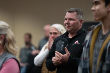 NIC Executive Director of Workforce and Economic Development Colby Mattila celebrates with others during a special board meeting on Monday at the Lake Coeur d’Alene Room of the Edminster Student Union Building on NIC’s Coeur d’Alene campus.