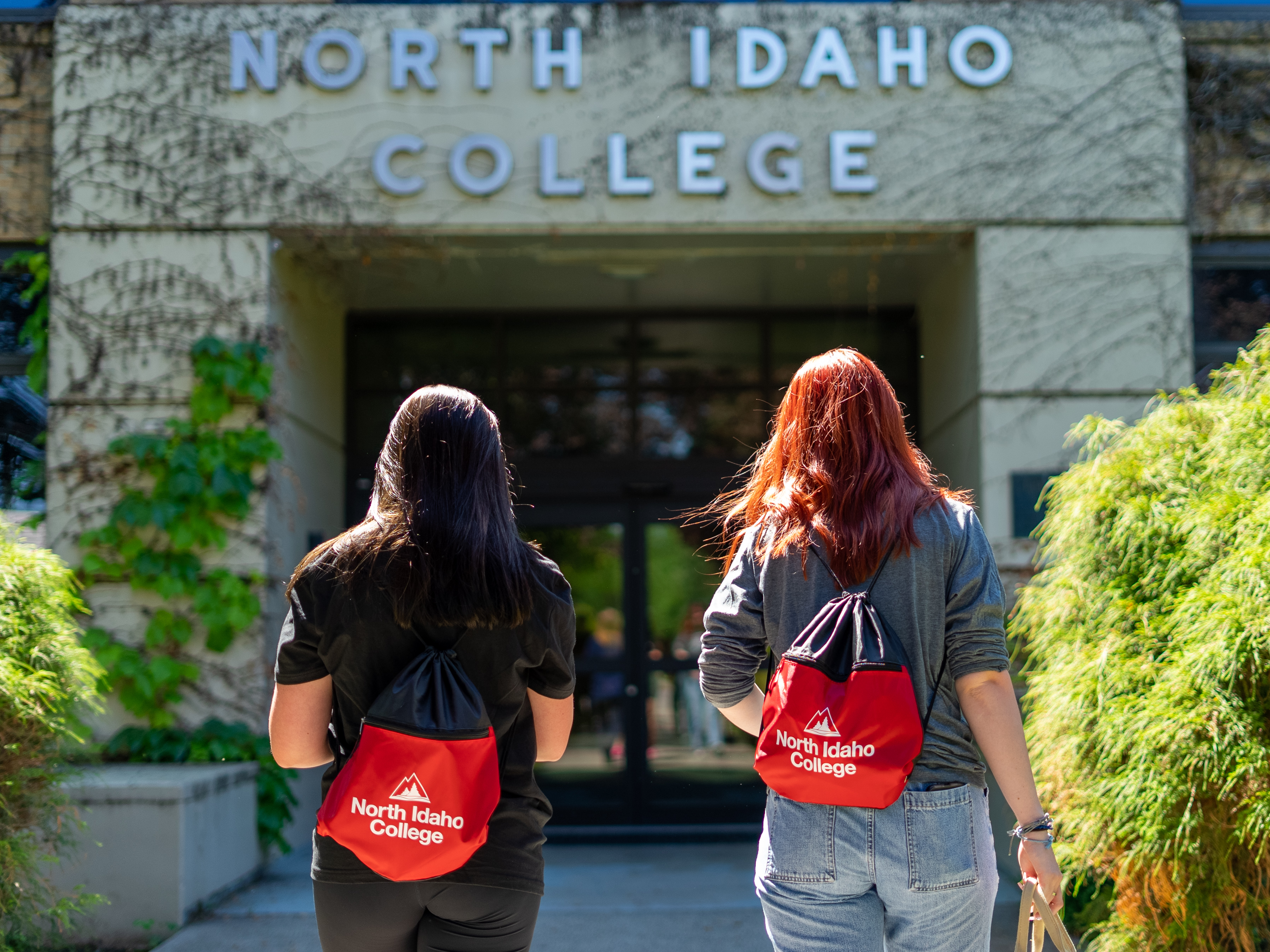 2 Female students walking into building