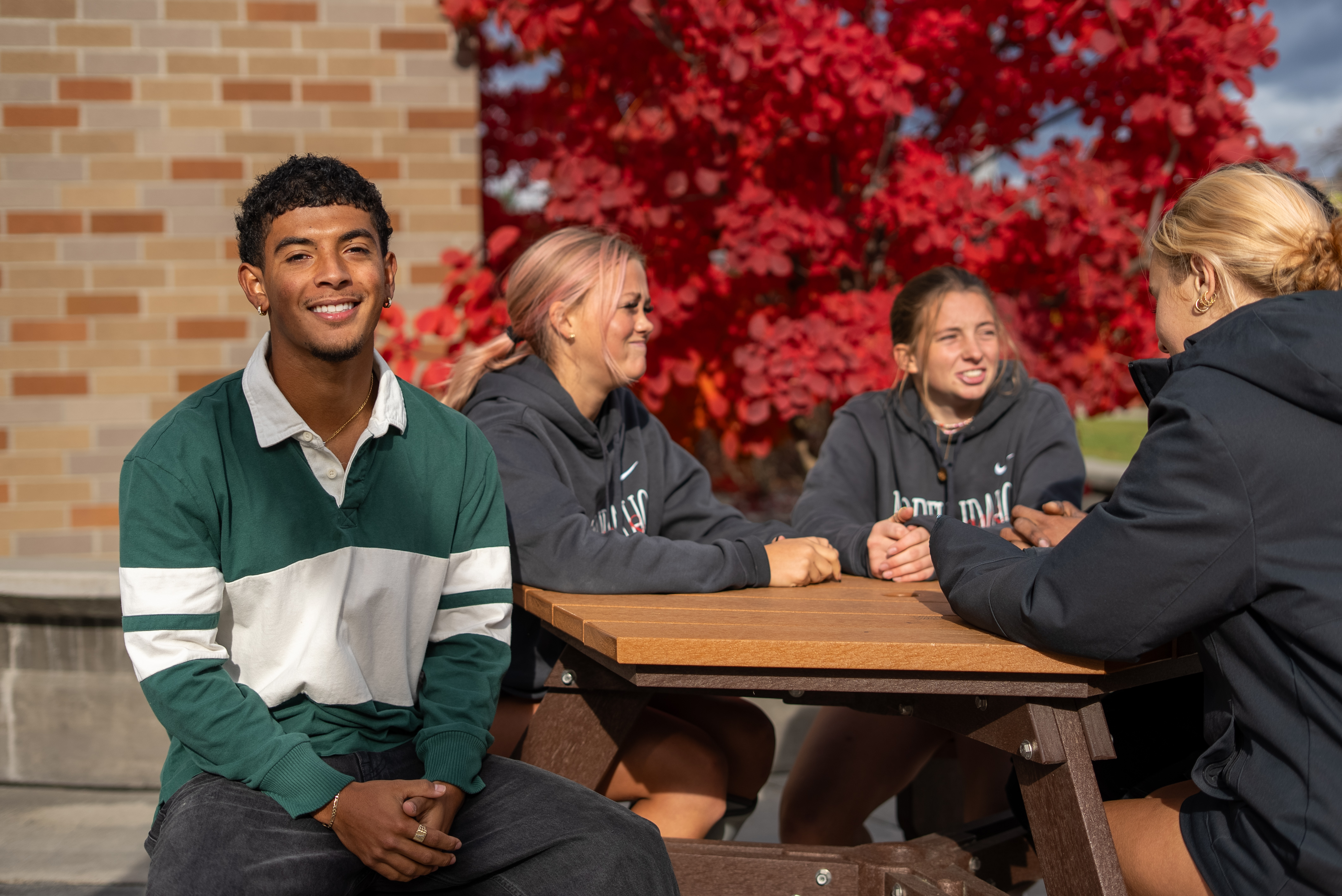 students outside talking at a table