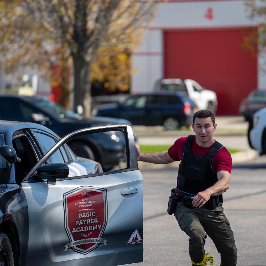 Police academy student running out of patrol car