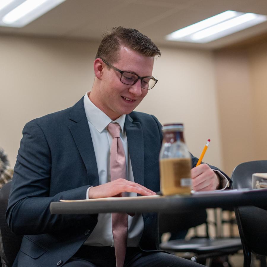 Student in suit taking test