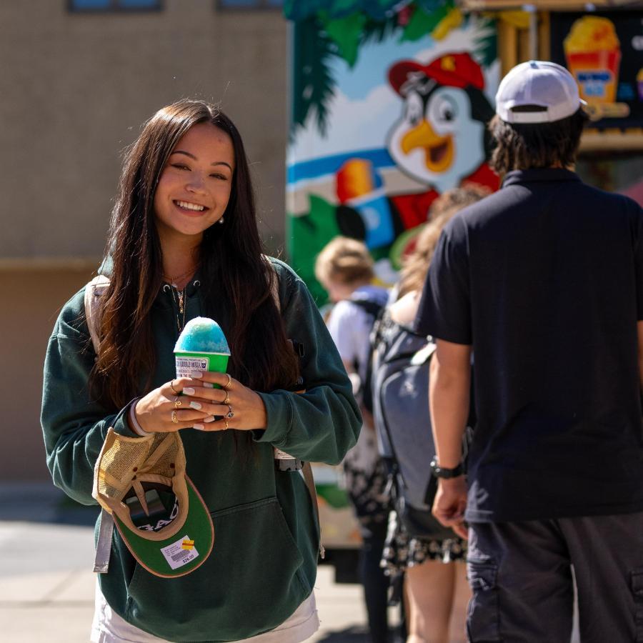 Student on First day of School holding a snow cone