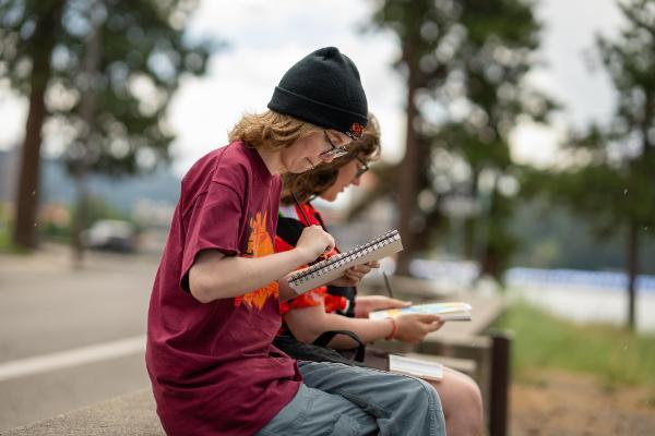 2 female students outside drawing