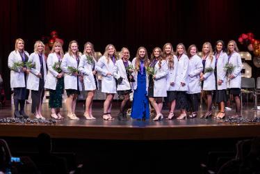 From left, NIC Dental Hygiene graduates Alexis, Alyssa, Kalli, Sonya, Jessie, Lauren, Angelea, Brooke, Reanna, Julissa, Shaylie, Bailey, Kelly, Emily and Bayleigh celebrate on stage during NIC’s dental hygiene graduation on Dec. 11 at the Boswell Hall Schuler Performing Arts Center at NIC’s Coeur d’Alene campus.