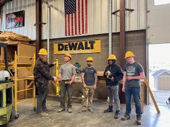 North Idaho College Workforce Training Center construction students pose with tools donated to the Workforce Training Center by the National Center for Construction and Education Research and DeWalt.