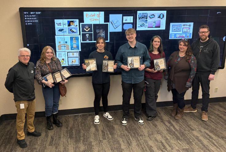 From left: Philippe Valle, NIC Associate Professor; Aurora Bacowsky; Gracie Duncan; Michael Cronin; Sarah Hoare; Lydia Ramus, NIC Adjunct Professor; and Jesse Longacre, NIC Assistant Professor. Students are standing in front of their award-winning designs.
