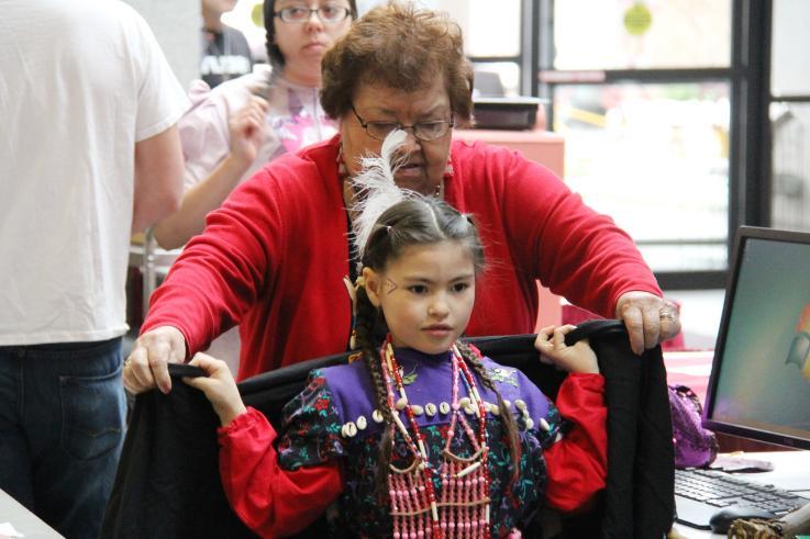 Freida Poirier helps Eva Dove Melting Tallow dress for an event at a previous American Indian Heritage Week