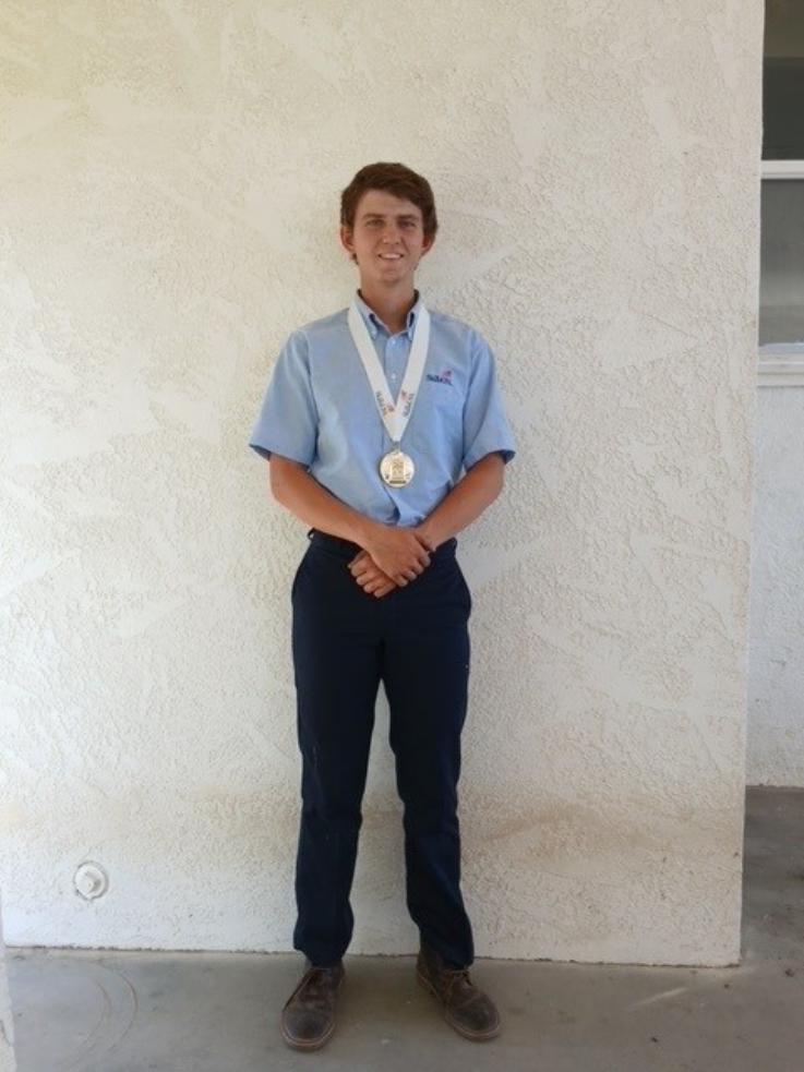Brunko poses for a photo wearing the gold medal he earned by winning the June 24 National SkillsUSA Collision Repair competition.