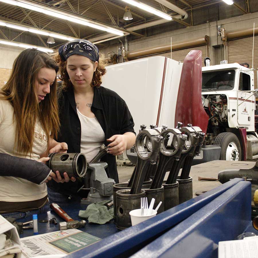 Female students working on Diesel Engine components