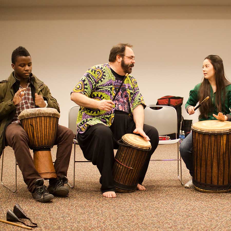 Students learning about drums from other cultures in a diversity class