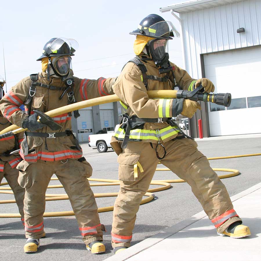 Fire Fighters working with hose to put out hazardous situation