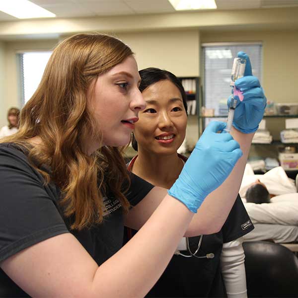 Registered Nursing students running test in the lab